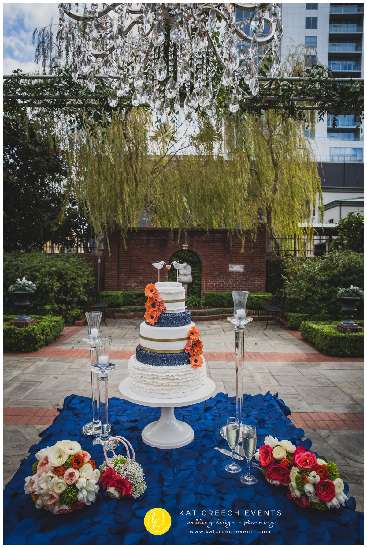 garden wedding | navy and coral wedding cake | wedding chandelier | Kat Creech Events